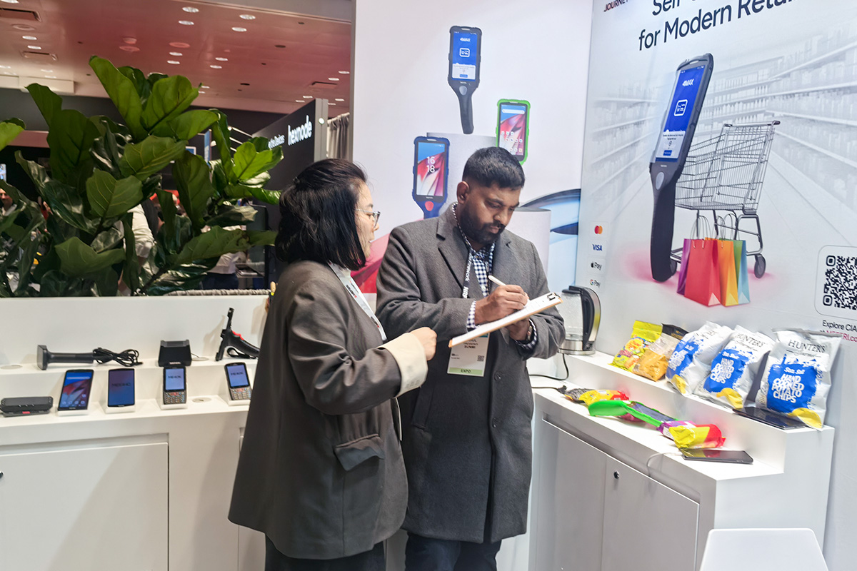 Attendees exploring MEFERI smart retail devices at NRF 2026